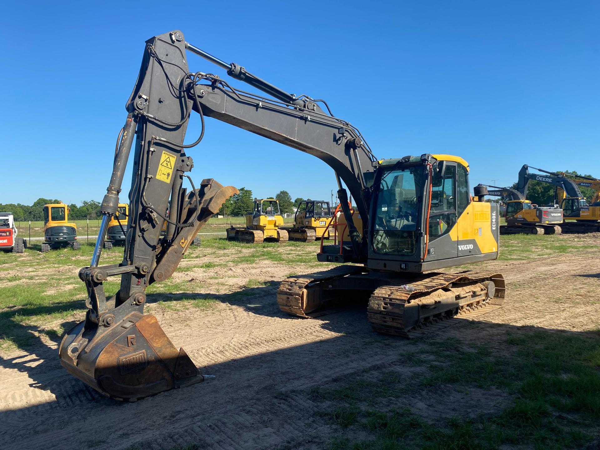 Fleet of yellow and black construction vehicles on site